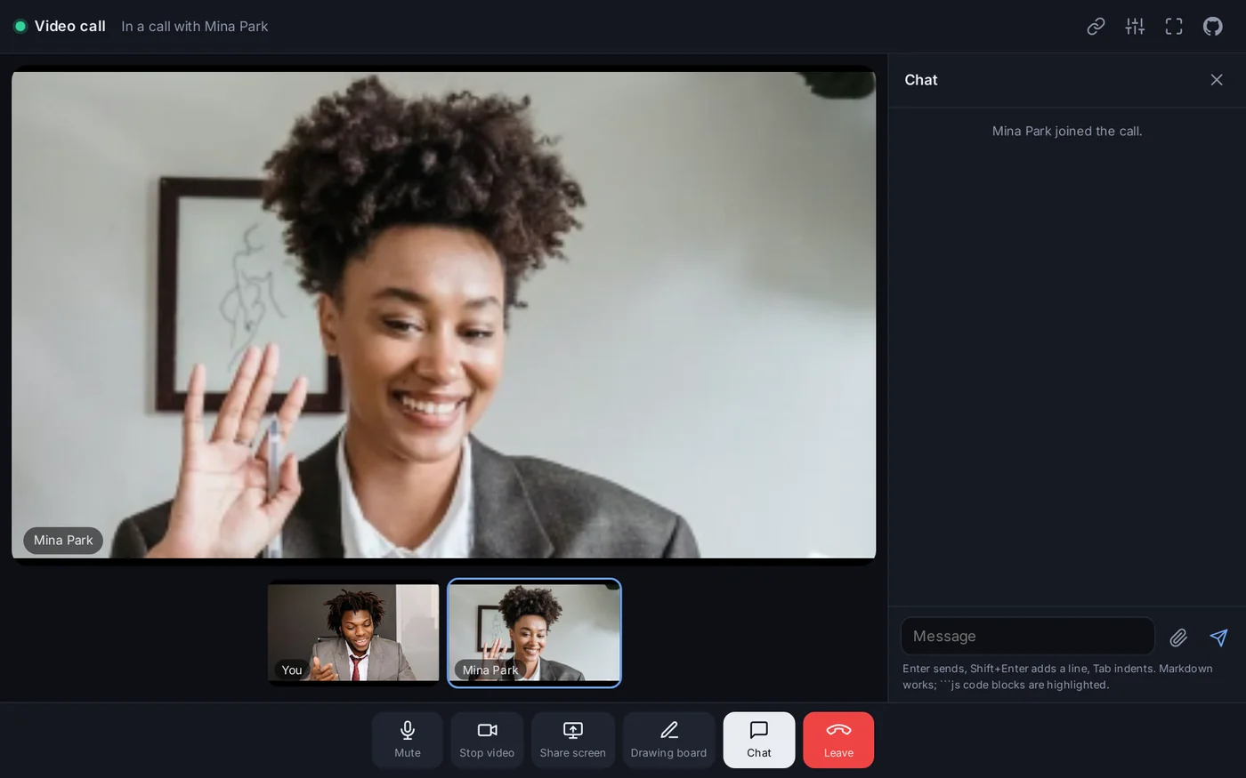 A call in progress: the other person on the stage, the two small pictures below it, and the chat open beside the call