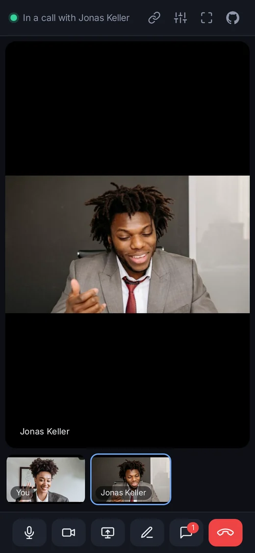 A call on a phone: the other person on the stage, the two small pictures, and the icon-only control bar